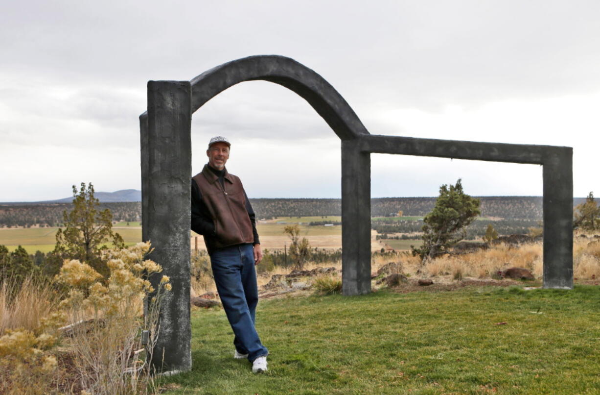 John Shepherd, who is pastor at his home church and officiant during the wedding ceremonies he hosts, stands against the archway at his venue, Shepherdsfield, outside Sisters, Ore., on Oct. 19, 2017.