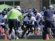 Seattle Seahawks strong safety Bradley McDougald (30) and linebacker Bobby Wagner (54) run an agility drill with teammates during NFL football training camp, Thursday, July 26, 2018, in Renton, Wash. (AP Photo/Ted S.