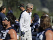 Seattle Seahawks head coach Pete Carroll smiles and he greets players at NFL football training camp, Thursday, July 26, 2018, in Renton, Wash. (AP Photo/Ted S.