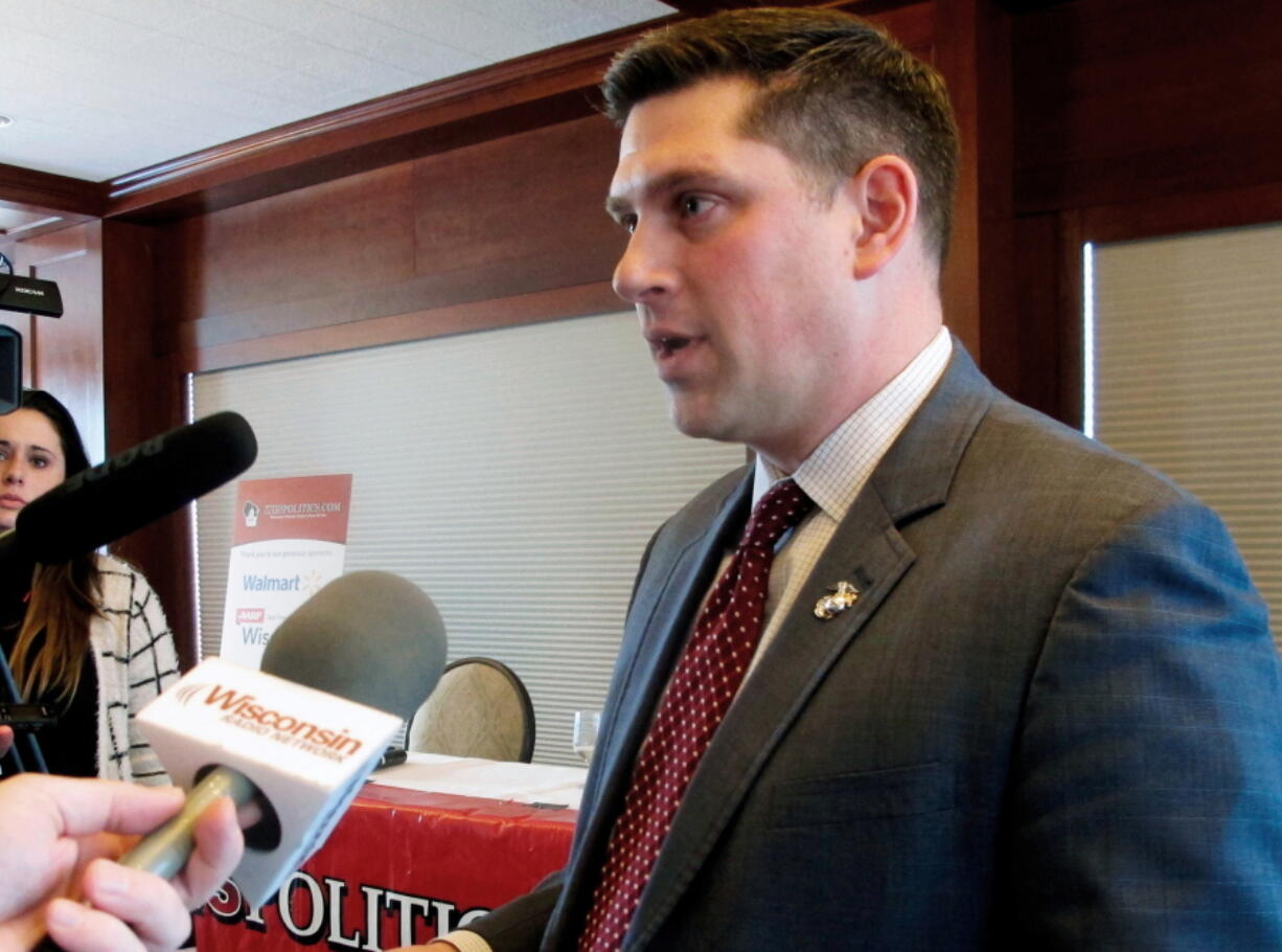 Wisconsin Republican Senate candidate Kevin Nicholson speaks with reporters in Madison, Wis. In an op-ed for Fox News published on Monday, July 16, 2018, Nicholson wrote about his parents’ support for his challenger, Democratic Sen. Tammy Baldwin. Nicholson says his parents’ decision to support his Democratic opponent is a “true representation” of political intolerance.