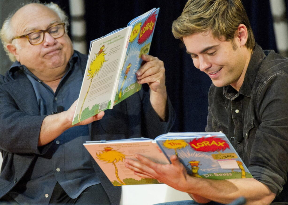 Stars Danny DeVito, left, and Zac Efron read “The Lorax” by Dr. Seuss to school children during the annual Read Across America Day at The New York Public Library in New York. Researchers at Dartmouth College, the alma mater of author and illustrator Theodore Geisel, better known as Dr. Seuss, said on Monday, July 23, 2018, that the furry orange protagonist of “The Lorax” and the Truffula trees may have been based on the patas monkey species and the whistling thorn acacia tree, both found in Kenya.