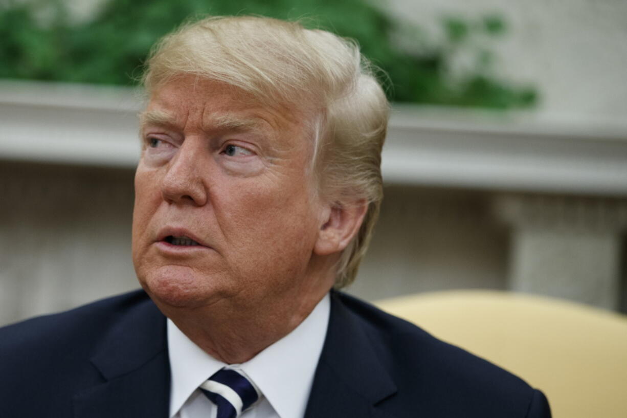 President Donald Trump listens during a meeting with Italian Prime Minister Giuseppe Conte in the Oval Office of the White House on Monday in Washington.