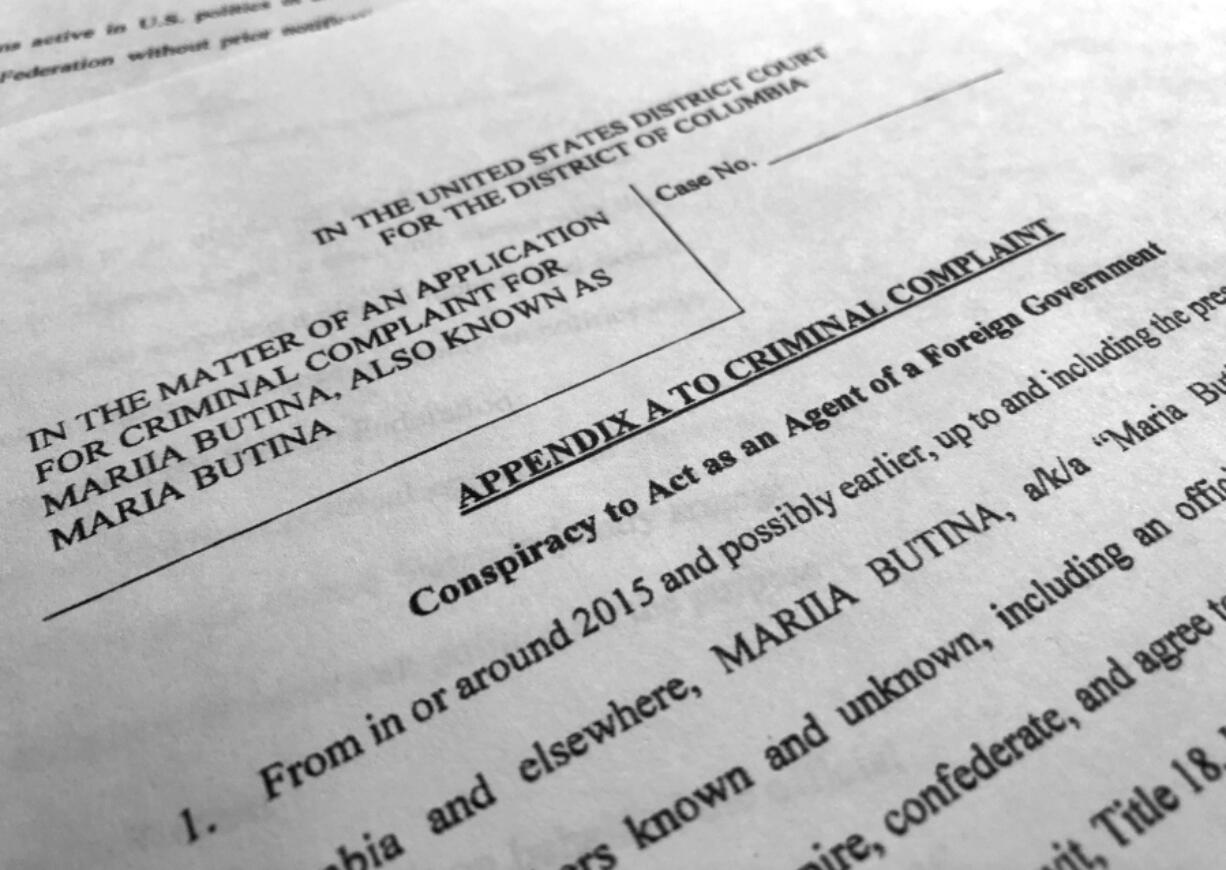 Court papers unsealed Monday, July 16, 2018, photographed in Washington, shows part of the criminal complaint against Maria Butina. She was arrested July 15, on a charge of conspiracy to act as an unregistered agent of the Russian government.