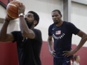 Kevin Durant, right, watches Kyrie Irving during a training camp for USA Basketball, Thursday, July 26, 2018, in Las Vegas.