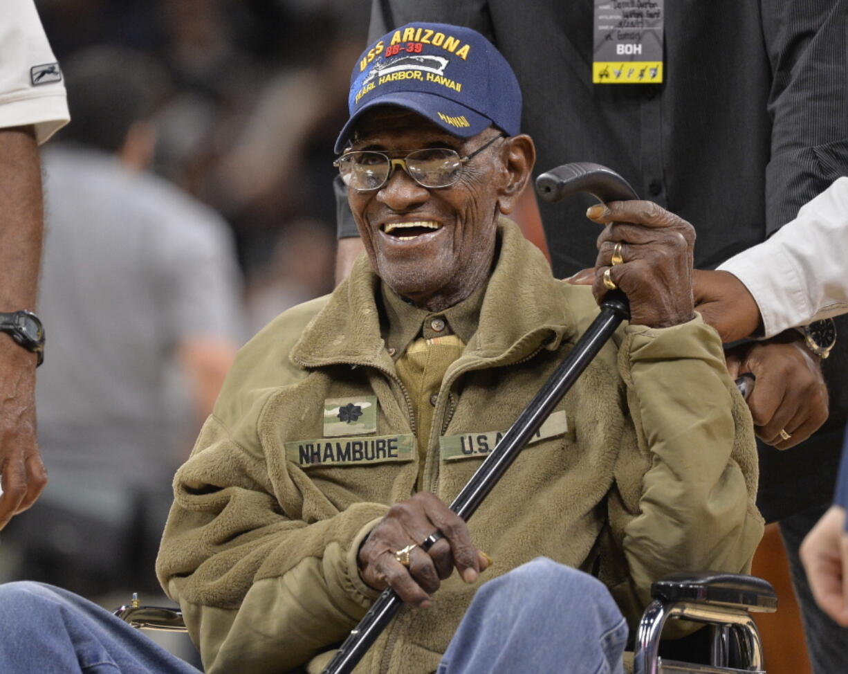 Richard Overton leaves the court after a special presentation honoring him as the oldest living American war veteran, during a timeout in an NBA basketball game between the Memphis Grizzlies and the San Antonio Spurs. The family of Richard Overton says Social Security and banking account numbers for the 112-year-old Austin man were used to make seven withdrawals over the past several months. Cousin Volma Overton declined to say how much was stolen but said it was a “significant amount of money.” He says the money was used to purchase savings bonds. A police report was filed Friday, June 30, 2018.