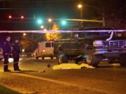 Vancouver police investigate the scene where a pedestrian was struck by an automobile and killed in Vancouver in December 2012.