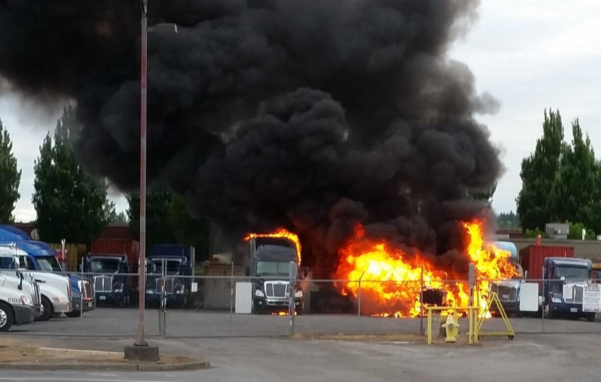 Several trucks burn early Saturday morning at a light industrial park on Southeast Columbia Way in Vancouver.