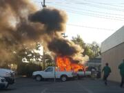 Fire burns in an SUV in the parking lot of an auto parts store in Vancouver Saturday evening. No injuries were reported.