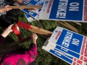 Teachers make signs Thursday after the Evergreen Education Association general membership meeting, where members voted in favor of a strike.