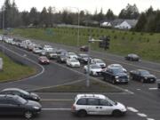 Vehicles traveling east on Highway 500 wait at the stoplight at the intersection of Falk Road during rush hour in February.