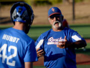 Manager Dave Chicks gives pointers to catcher Aidan Hundt (42) during a KWRL Centerfield Roosters U15 baseball team practice at Luke Jensen Park in Vancouver. The Roosters are preparing to compete in the 15U Babe Ruth World Series, Aug. 9-16 in Longview.