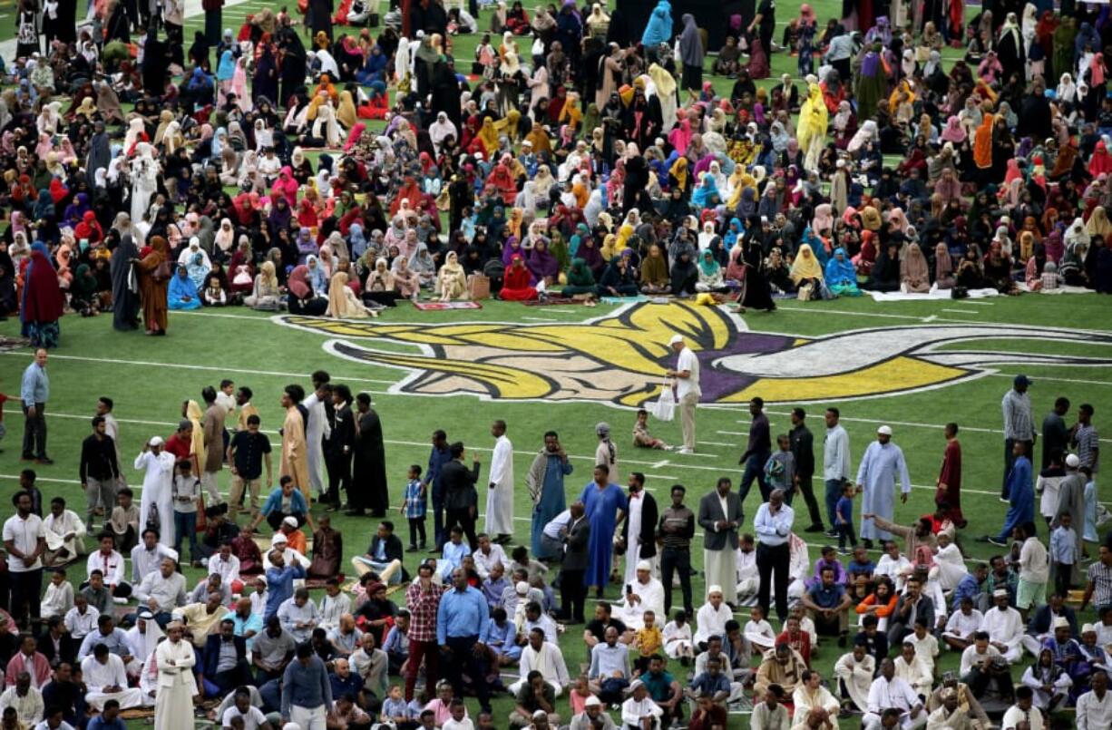 Muslim worshipers gather Tuesday on the field for the morning prayers for Eid ul-Adha at U.S. Bank Stadium in Minneapolis, Minn. To celebrate Eid ul-Adha, the organization Super Eid hopes to bring together over 50,000 Muslims to pray.