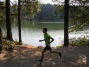 Washougal senior Gabriel Dinnel, here running by Round Lake in Camas, loves the variety of courses and challenges that cross country offers.