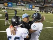 Hockinson head coach Rick Steele congratulates Robert Flores (56) and Sawyer Racanelli (11) after winning the 2A state football championship game against Tumwater on Saturday, Dec. 2, 2017, in Tacoma, Wash. Hockinson defeated Tumwater 35-22 to win their first state title.