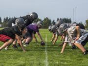 Heritage linemen perform a snapping drill during a practice. The Timberwolves return eight starters on defense.