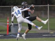 Hockinson wide receiver Sawyer Racanelli, right, pulls in a touchdown pass as Liberty defensive back Caleb Carr defends in the 2A state football quarterfinals.