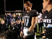 Hockinson Hawks Sawyer Racanelli (11) smiles with teammates after the Hawks beat  the Aberdeen Bobcats, 49-8, in 2A GSHL football playoffs at Battle Ground District Stadium on Friday, Nov. 4, 2017. Photo by Randy L.