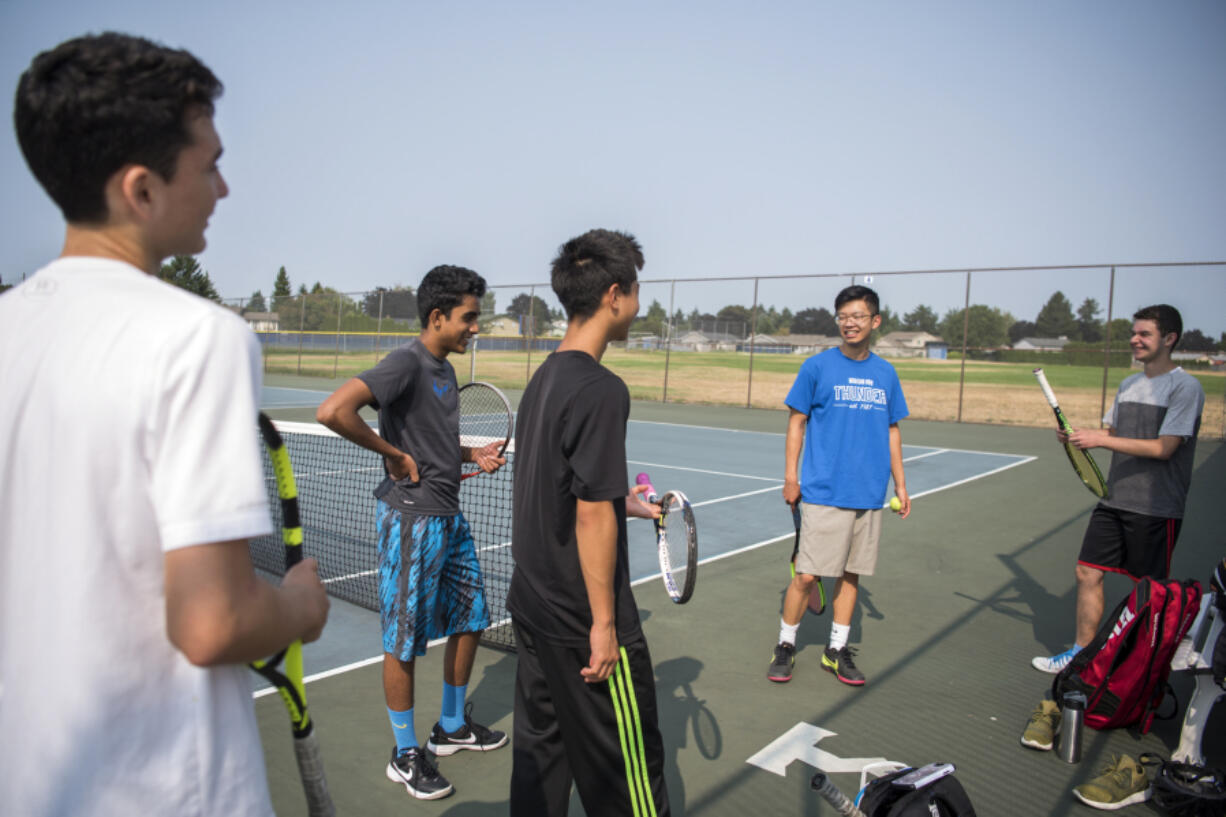 Mountain View freshman James Bertheau, left, sophomore Nathaniel John, sophomore Vincent Hsu, junior Jerry Huang, and senior Darius Leahu take a water break during an informal summer hit session.