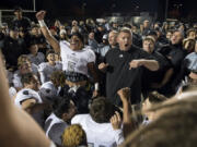 Alisha Jucevic/The Columbian Quarterback Lincoln Victor, left, and coach Rory Rosenbach lead a celebration after Union beat Camas 14-13 last year. The victory ended the Papermakers’ seven-year run of league titles and established the Titans as the team to beat.