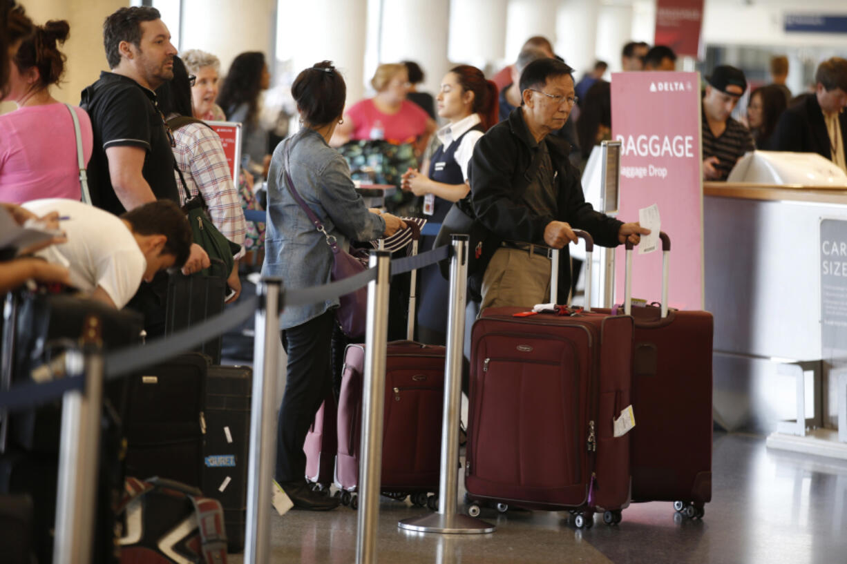 Long lines congest Los Angeles International Airport on the Friday before Labor Day in 2015.