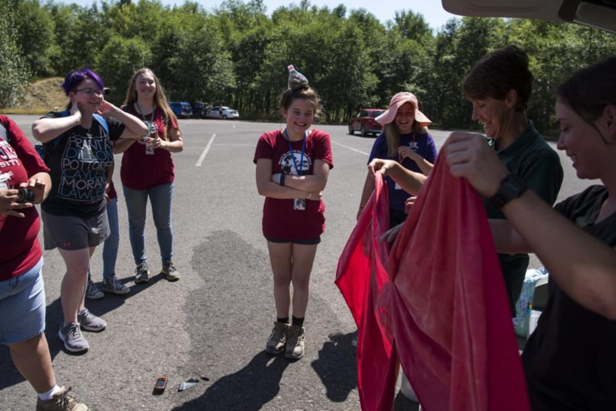 Members of GeoGirls geology and technology field camp burst into laughter as a 5-foot helium balloon pops before a mapping exercise at Mount St. Helens on Wednesday. The group decided to troubleshoot the situation and found ways to complete the mapping exercise by foot instead of with the balloon.