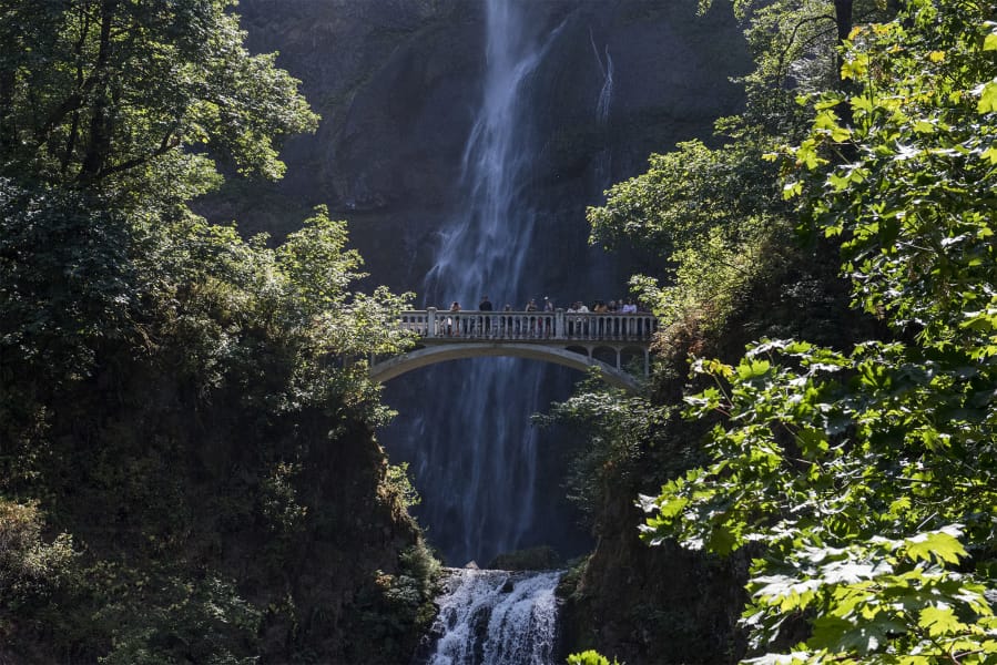 Visitors standing on the Benson Footbridge take in the vista of Multnomah Falls. The Columbia River Gorge National Scenic Area’s marquee site is open, but there are many other impressive sites just down the road.