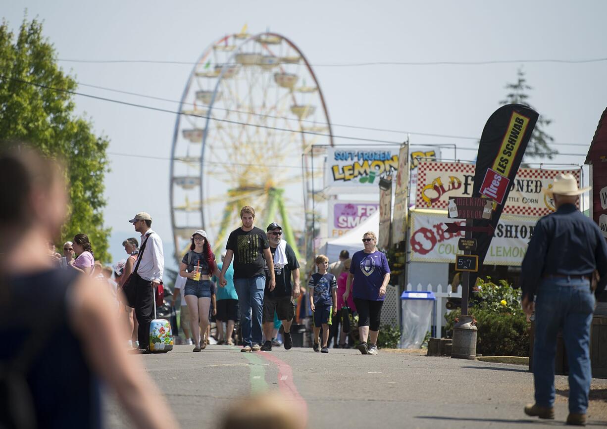 Crowds pass rides, food and exhibits as they stroll among the attractions at the Clark County Fair on Monday afternoon.