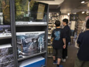 Visitors to the Multnomah Falls Lodge in Oregon look through the gift shop, which sustained heavy smoke damage during the Eagle Creek Fire last summer.