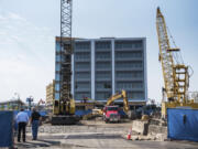 Dean Kirkland, chairman of Kirkland Development LLC, left, oversees work on a two-floor underground parking garage that will serve Hotel Indigo at The Waterfront Vancouver development on Monday afternoon. Set to open in 2020, the hotel is part of a huge swell in Vancouver’s tourism capacity expected to increase by 30 percent in five years.