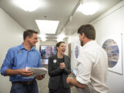 Campaign manager Wyatt Arnall, from left, Carolyn Long, Democratic candidate for the 3rd Congressional District, and campaign consultant Parker Butterworth react to the election results Tuesday night at the Clark County Public Service Center.