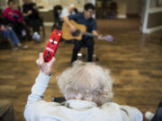 A resident shakes a tambourine along to “You Ain’t Nothin’ But A Hound Dog.” Daniel Maruyama tries to fill the hourlong session with songs that the residents would have listened to when they were growing up.