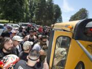 Patriot Prayer supporters board a bus Saturday at Marine Park in Vancouver for the trip to downtown Portland to attend a rally.