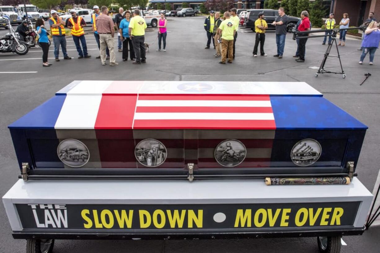 A crowd gathers around the Spirit Ride casket at Pacific Towing in Vancouver on Friday.