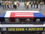 A crowd gathers around the Spirit Ride casket at Pacific Towing in Vancouver on Friday.