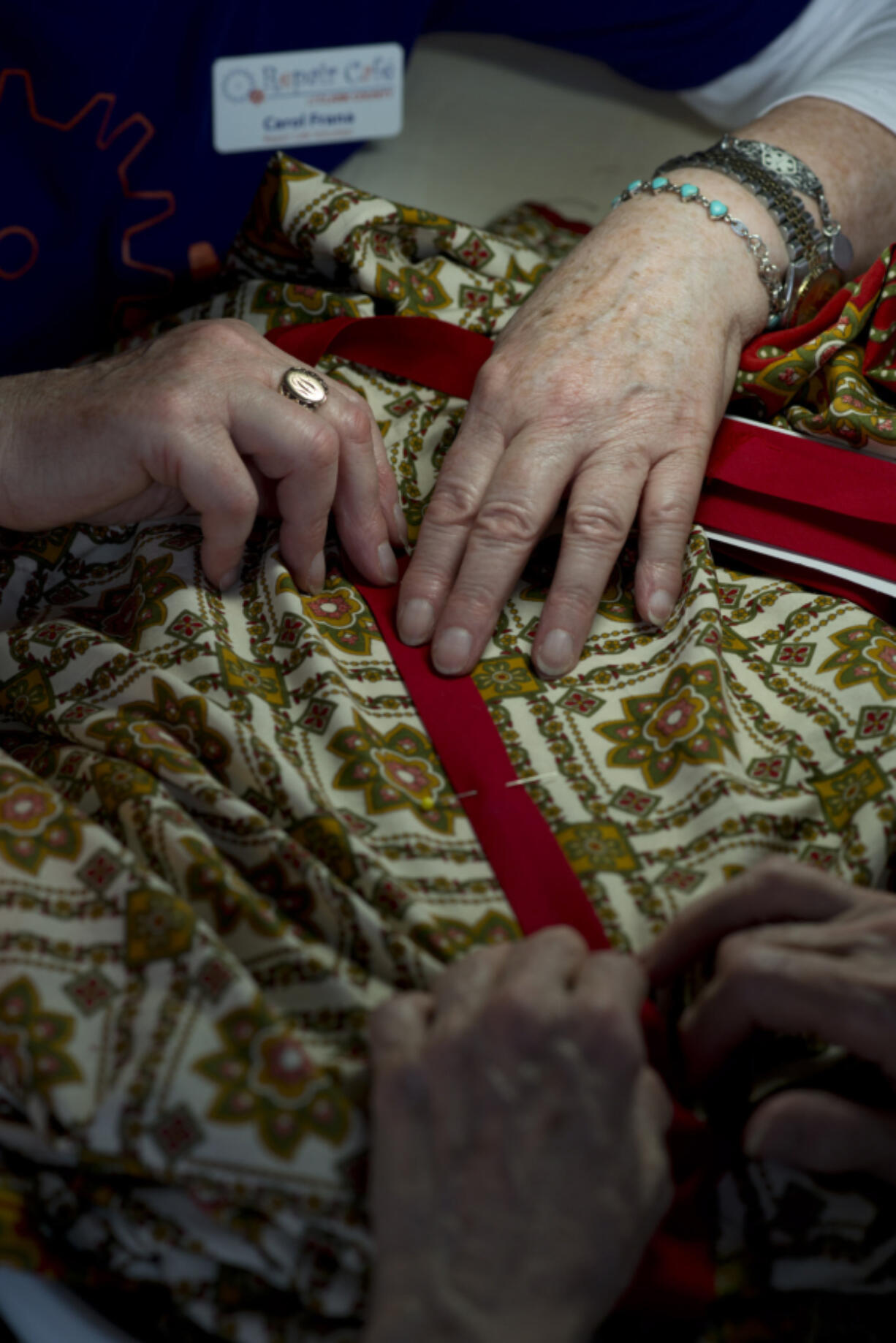 Carol Frana of Vancouver works to repair Marcia Crane’s colorful patterned blouse at the Aug. 9 Repair Cafe in Hazel Dell.