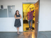 Tracy and Ty Camp pose at the entrance to the grow room at Sunshine Farms. Ty Camp owns the business, but Tracy Camp ultimately lost her banking job as a result.