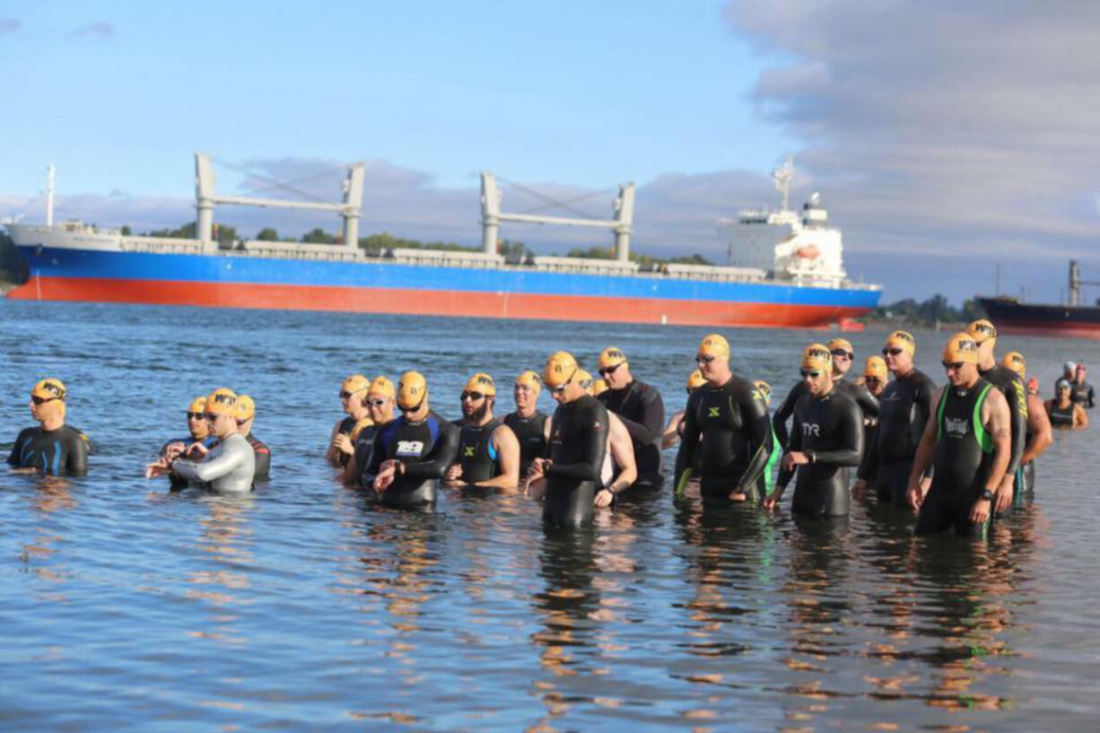 Competitors get ready to swim the Columbia River during a previous triathalon.