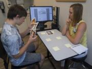 Jack Bellamy, 15, of Ridgefield, left, uses sequencing cards during cognitive therapy with speech language pathologist Melissa Bohnstedt at PeaceHealth Southwest Medical Center in Vancouver.