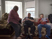 Ombudsman Joan McConnell, from left, Wilfred Lirette Jr. and Henry Cayton speak about the ombudsman program at an adult family home in Vancouver. McConnell started volunteering with the program about a decade ago. The program is in need of more volunteers.