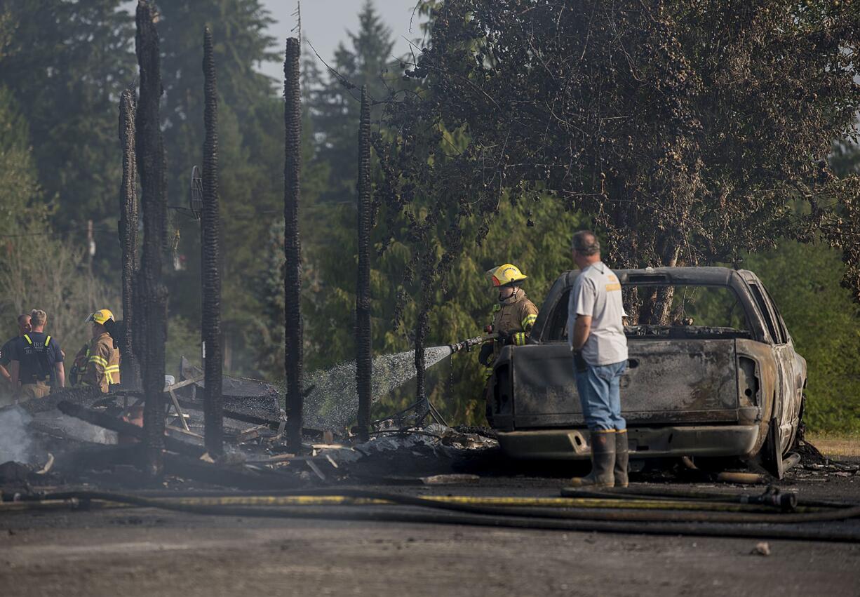 Firefighters work at the scene of a house fire in Ridgefield where 23-year-old Stefany Cutler-Ffitch died trying to save her pug Mario on the morning of Aug. 8.