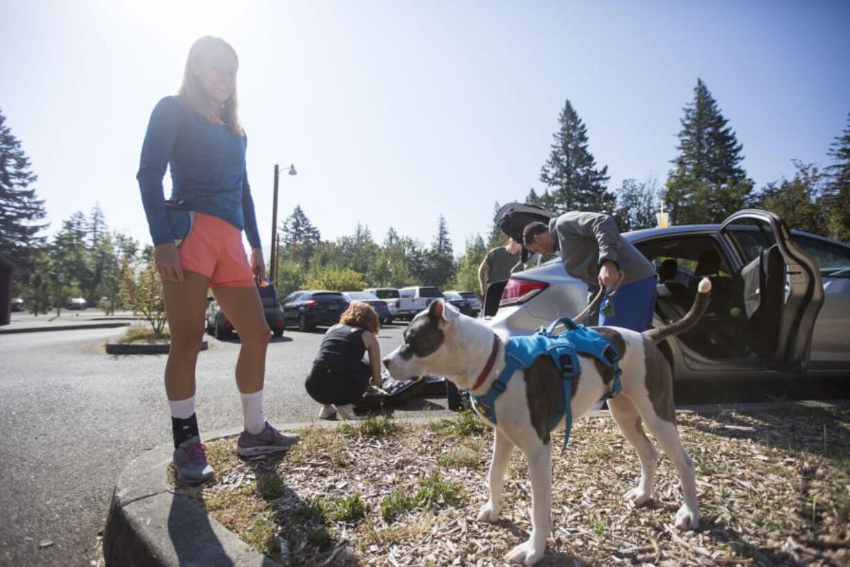 Claire Francis of Beaverton, Ore., left, prepares with her family to hike the Cape Horn Trail from the packed Salmon Falls Road Park & Ride lot. Since the Eagle Creek fire, Francis said, she’s been crossing the river to hike the Washington side of the Gorge more.