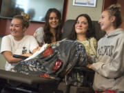 Jordan Holgerson, in chair, is surrounded by friends and family while joking with the media about her injuries at PeaceHealth Southwest Medical. Surrounding Holgerson are, from left, friend Masey Tucker, sister Kaytlin Holgerson and friend Taylor Lavigne.