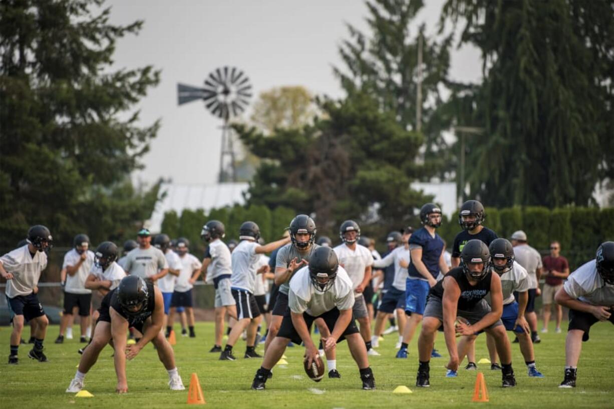 Hockinson players prepare to run a passing drill during the first practice of the year at Hockinson High School on Wednesday afternoon.