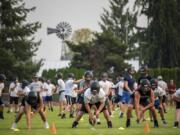 Hockinson players prepare to run a passing drill during the first practice of the year at Hockinson High School on Wednesday afternoon.