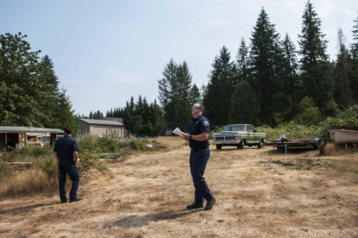 Fire Marshal Chris Drone, left, and Risk Specialist Jacob Guisinger lead a wildfire survey at a rural home on Thursday afternoon.