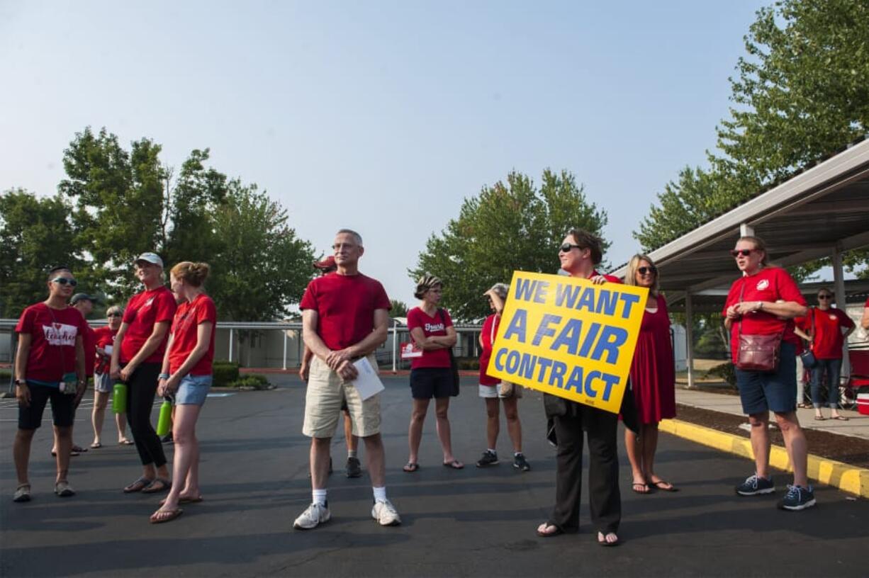 Evergreen Education Association union members and supporters protest while attending an Evergreen Public School Board meeting on Tuesday evening.