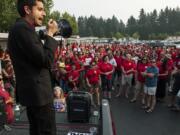 Adam Aguilera, an English teacher at Heritage High School, speaks to a crowd of Evergreen Education Association union members and supporters while protesting during an Evergreen Public Schools board meeting on Tuesday evening. Union members have called the district’s proposed 1.9 percent raise insulting, while district officials say adopting the union’s proposed salary schedule will drive the district nearly $53 million in the hole.