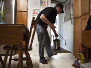 Gabriel Bunker, technician with Antworks Pest Control, sprays Transport Mikron around the floorboards of a home in north Vancouver on Friday while searching for sugar ants.