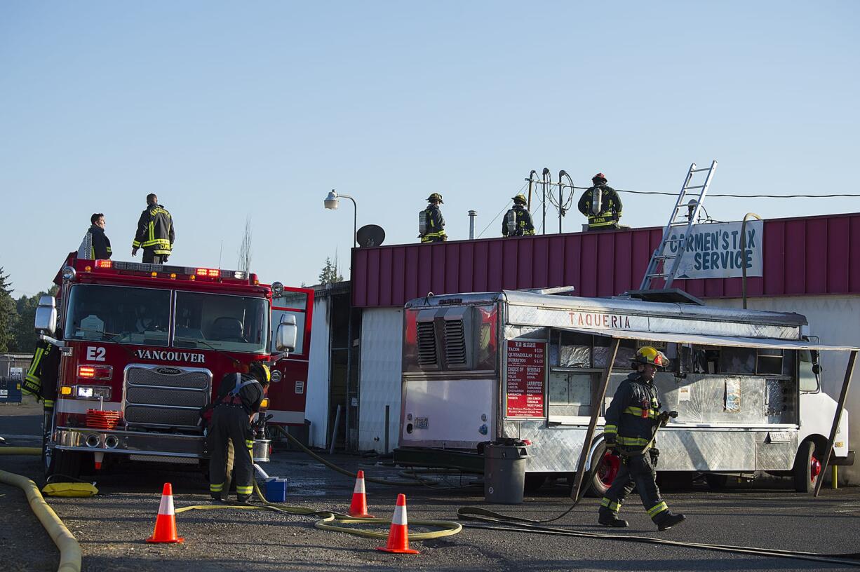 Firefighters work at the scene of a blaze at Vick's Market at 4903 East Fourth Plain Boulevard on Friday evening, Aug. 17, 2018. No injuries were reported in the fire, which was reported to have started in a room in the back of the store and then spread to the attic.