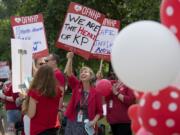 Mental health therapist Wendy Del Mar, center, joins fellow employees outside the Kaiser Permanente Cascade Park office as they rally in favor of staffing improvements and better patient care Tuesday afternoon.